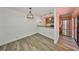Open dining area featuring wood-look flooring, decorative lighting, and a pass-through to the kitchen at 2627 2Nd Ct, Palm Harbor, FL 34684