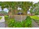 Townhome exterior features a wooden fence surrounding a landscaped yard with a gazebo at 2627 2Nd Ct, Palm Harbor, FL 34684
