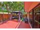 Outdoor patio features a gazebo with seating, lush landscaping, and a sliding glass door at 2627 2Nd Ct, Palm Harbor, FL 34684
