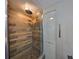 Stylish shower featuring wood-look tile surround, a rain shower head, and a built-in niche for storage at 2627 2Nd Ct, Palm Harbor, FL 34684