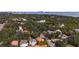 Panoramic aerial view of a neighborhood with mature trees and a glimpse of the distant waterfront and city at 2701 W Bay Ave, Tampa, FL 33611