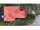 Aerial view of home showing red roof, manicured landscaping, paver driveway, and a screened in outdoor space at 2701 W Bay Ave, Tampa, FL 33611