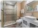 Updated bathroom featuring tiled shower with glass door, modern vanity, and decorative mosaic accents at 2701 W Bay Ave, Tampa, FL 33611