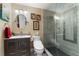 Nicely remodeled bathroom features a vanity, toilet, and a glass shower with decorative gray tile border at 2701 W Bay Ave, Tampa, FL 33611
