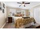 Cozy bedroom features a large bed with palm patterned bedding, side tables with lamps and bright windows at 2701 W Bay Ave, Tampa, FL 33611