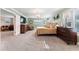 Bright main bedroom features a bed, wooden furniture and walls, with an attached living area at 2701 W Bay Ave, Tampa, FL 33611
