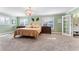 The main bedroom features a large bed, green walls, neutral carpet, and shuttered windows at 2701 W Bay Ave, Tampa, FL 33611