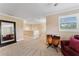 Bonus room with neutral walls, carpeted floors, and large mirror that maximizes the space and light at 2701 W Bay Ave, Tampa, FL 33611