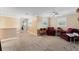 Spacious carpeted bonus room with neutral walls, ample natural light, and comfortable seating area for relaxing at 2701 W Bay Ave, Tampa, FL 33611