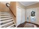 Entryway with a decorative door, staircase, and dark wood flooring at 2701 W Bay Ave, Tampa, FL 33611