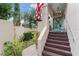 Inviting front entrance with a vibrant blue door, landscaped steps, and charming decorative accents at 2701 W Bay Ave, Tampa, FL 33611