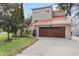 Inviting home with a red tile roof, a paver driveway, and a well-manicured lawn at 2701 W Bay Ave, Tampa, FL 33611