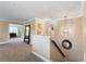 Upstairs hallway with carpeted floors, light tan colored walls, and white trim around the doors and ceilings at 2701 W Bay Ave, Tampa, FL 33611