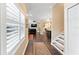 View of the hallway leading to the living room with hardwood floors and a staircase at 2701 W Bay Ave, Tampa, FL 33611