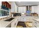 Well-appointed kitchen area featuring granite countertops, stainless steel appliances and sleek white cabinetry at 2701 W Bay Ave, Tampa, FL 33611
