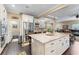 This kitchen features stainless appliances, granite counters, an island with seating and an entrance to the laundry room at 2701 W Bay Ave, Tampa, FL 33611