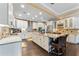 Bright, spacious kitchen features granite countertops, white cabinetry, stainless appliances, and large island with barstool seating at 2701 W Bay Ave, Tampa, FL 33611
