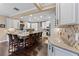 Large kitchen with white cabinetry, granite countertops, stainless steel appliances, and a spacious center island with barstool seating at 2701 W Bay Ave, Tampa, FL 33611