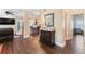 Open-concept living room with hardwood floors, a dark wood dresser, and a view of the kitchen at 2701 W Bay Ave, Tampa, FL 33611