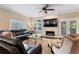 Cozy living room with fireplace, ceiling fan, and French doors leading to the outside at 2701 W Bay Ave, Tampa, FL 33611