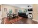 Well-decorated living room with a fireplace, hardwood floors, and natural light at 2701 W Bay Ave, Tampa, FL 33611