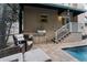 Outdoor kitchen and lounge area by the screened in pool, perfect for outdoor relaxation and entertaining at 2701 W Bay Ave, Tampa, FL 33611