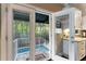 View from kitchen to screened pool with outdoor living space, perfect for entertaining and relaxation at 2701 W Bay Ave, Tampa, FL 33611