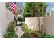 Landscaped yard with brick pathway, wrought iron gate, mature trees and privacy wall at 2701 W Bay Ave, Tampa, FL 33611