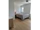 Neutral bedroom features wood floors, a ceiling fan, and natural light from two windows at 320 Capstan Dr, Placida, FL 33946
