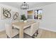 Bright dining area with a modern light fixture and large window view at 3544 Edenwood Dr, Holiday, FL 34691