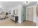 Bright entryway with light wood floors, stylish console table, and a charming teal front door at 3544 Edenwood Dr, Holiday, FL 34691