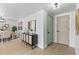 Bright entryway with light wood floors, stylish console table, and a charming teal front door at 3544 Edenwood Dr, Holiday, FL 34691