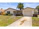 Inviting single-story home with attached garage and a well manicured front yard and clear driveway at 3544 Edenwood Dr, Holiday, FL 34691