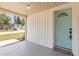 Close-up of the front porch highlighting the teal front door and covered entrance at 3544 Edenwood Dr, Holiday, FL 34691
