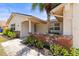 Inviting front porch with brick accents, lush greenery, and a charming blue front door at 3544 Edenwood Dr, Holiday, FL 34691
