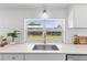 Bright kitchen sink area with white subway tile backsplash and modern fixtures at 3544 Edenwood Dr, Holiday, FL 34691
