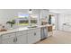 Updated kitchen sink with white cabinets and subway tile backsplash at 3544 Edenwood Dr, Holiday, FL 34691