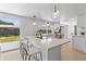 Updated kitchen with a long quartz countertop island and stainless steel appliances at 3544 Edenwood Dr, Holiday, FL 34691