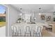 Bright kitchen with white cabinets, quartz countertops, and a breakfast bar with modern stools at 3544 Edenwood Dr, Holiday, FL 34691
