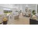Open-concept living space with modern furnishings and seamless flow to the updated kitchen and backyard access at 3544 Edenwood Dr, Holiday, FL 34691