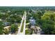 High angle view of houses bordering a golf course and a long winding street lined with greenery at 3728 Parkway Blvd, Land O Lakes, FL 34639