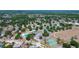 Wide aerial shot showcasing the tennis courts, pool, basketball court, running track, and neighborhood at 3728 Parkway Blvd, Land O Lakes, FL 34639