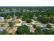Aerial view showcases neighborhood near a lake surrounded by lush greenery and winding roads at 3728 Parkway Blvd, Land O Lakes, FL 34639