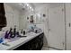 A bathroom with sink, mirror, vanity, and patterned wallpaper at 3728 Parkway Blvd, Land O Lakes, FL 34639