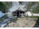 Exterior view of the home featuring a screened-in porch and fenced yard at 3728 Parkway Blvd, Land O Lakes, FL 34639