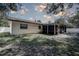 Exterior view of the home featuring a screened-in porch at 3728 Parkway Blvd, Land O Lakes, FL 34639