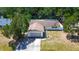 Aerial view of a single-story home featuring a lawn, driveway, and mature trees at 3728 Parkway Blvd, Land O Lakes, FL 34639