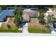 Aerial view of a single-story home with a lawn, driveway, and trees in a residential neighborhood at 3728 Parkway Blvd, Land O Lakes, FL 34639