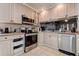 Functional kitchen featuring modern appliances, ample cabinet space, and tiled floors at 3728 Parkway Blvd, Land O Lakes, FL 34639