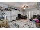 Open-concept living area with ceiling fan and wood flooring, featuring a bed at 3728 Parkway Blvd, Land O Lakes, FL 34639